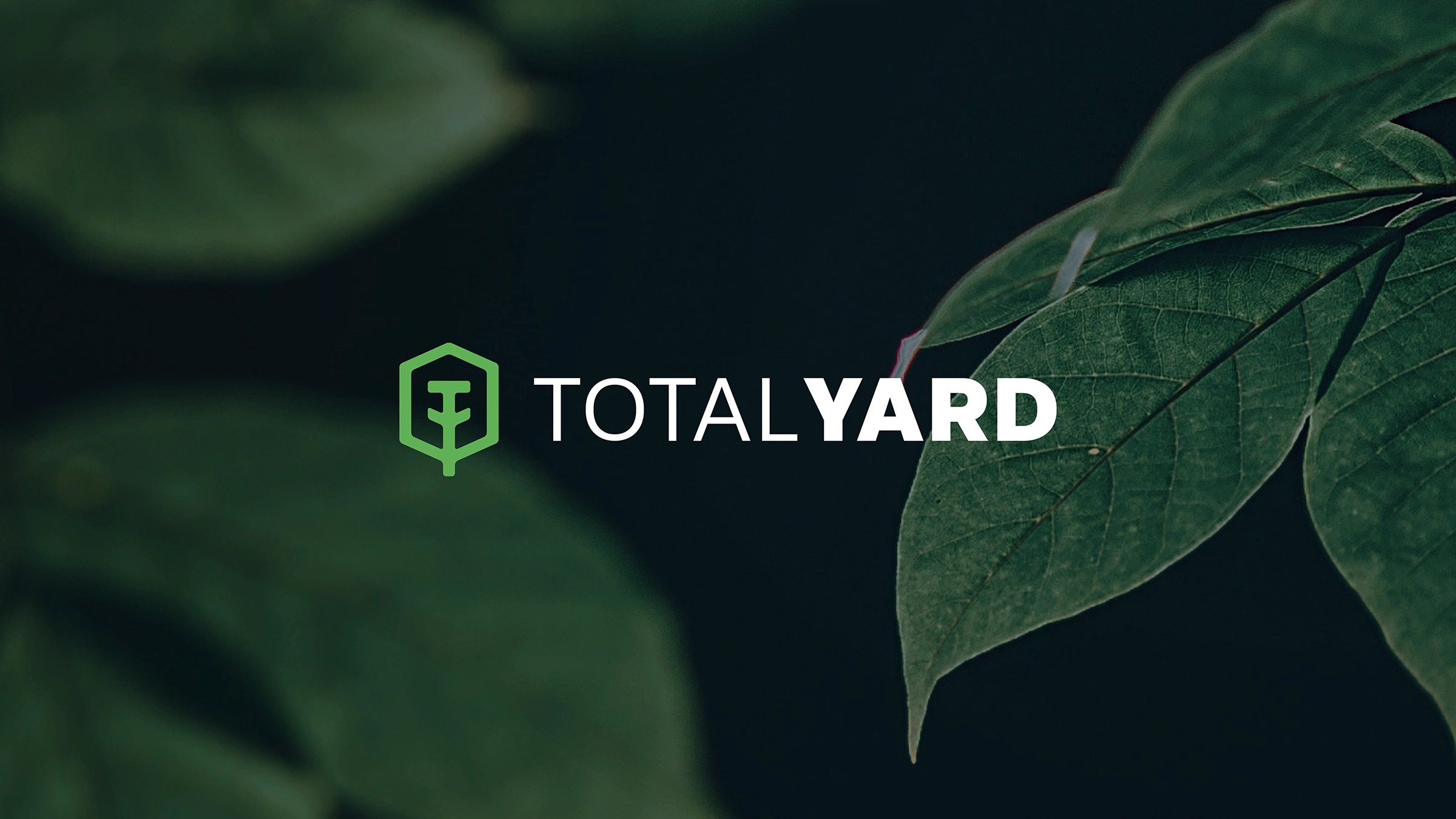Total Yard's logo over a few leaves